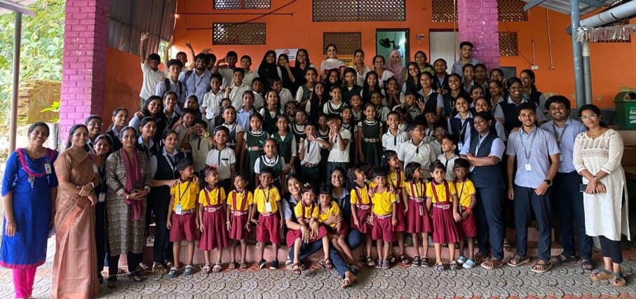 The full group — Sankofa Club student volunteers, faculty, teachers and the children of Echipparra Tribal School — gathered on the school veranda for a group photograph.